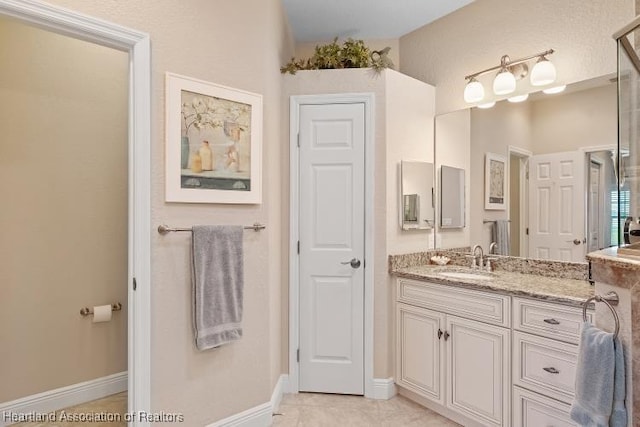 bathroom with tile patterned flooring and vanity