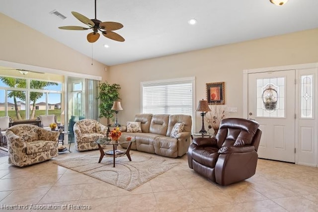 tiled living room with ceiling fan and lofted ceiling