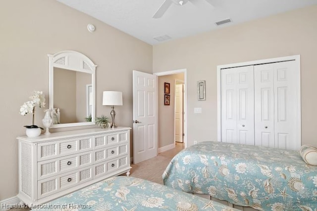 carpeted bedroom featuring ceiling fan and a closet