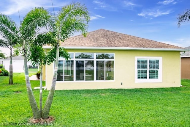 rear view of house featuring a lawn