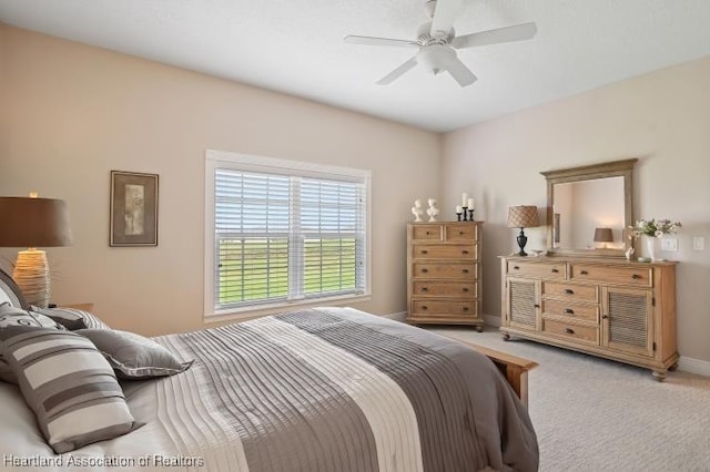 bedroom featuring ceiling fan and light colored carpet