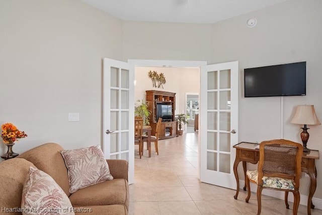 living room featuring french doors and light tile patterned floors