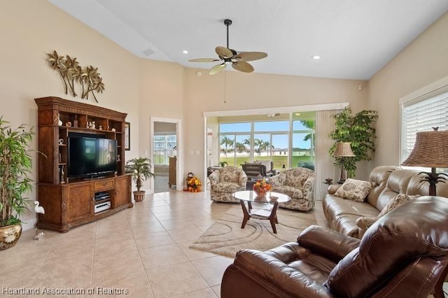 living room featuring ceiling fan, a healthy amount of sunlight, light tile patterned flooring, and high vaulted ceiling