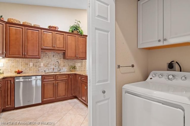 laundry area with light tile patterned floors, sink, and washer / clothes dryer