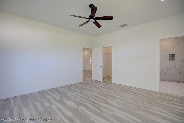 interior space with light wood-type flooring and ceiling fan