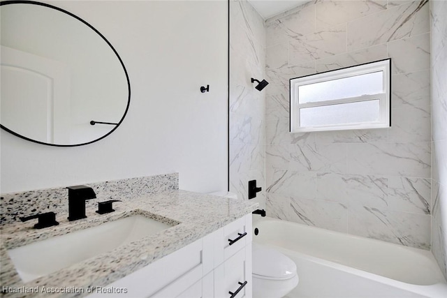 full bathroom with vanity, toilet, and tiled shower / bath