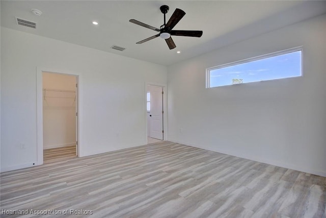 empty room featuring ceiling fan and light hardwood / wood-style floors