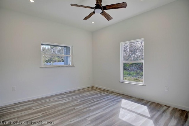 empty room featuring ceiling fan and light hardwood / wood-style flooring