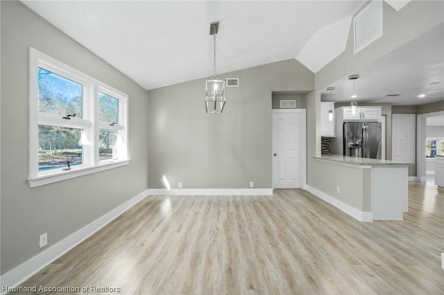 interior space with light hardwood / wood-style flooring and lofted ceiling