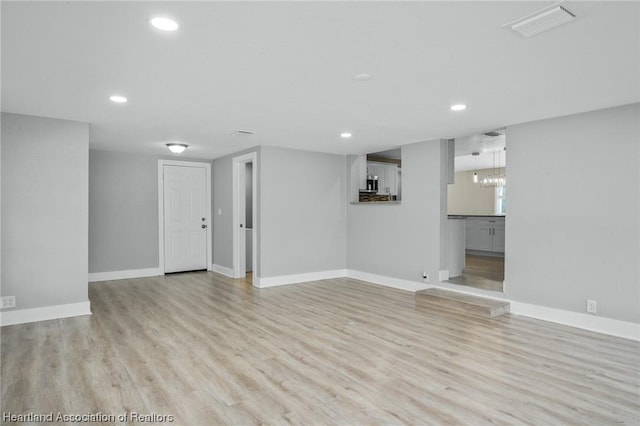 interior space featuring a chandelier and light hardwood / wood-style floors