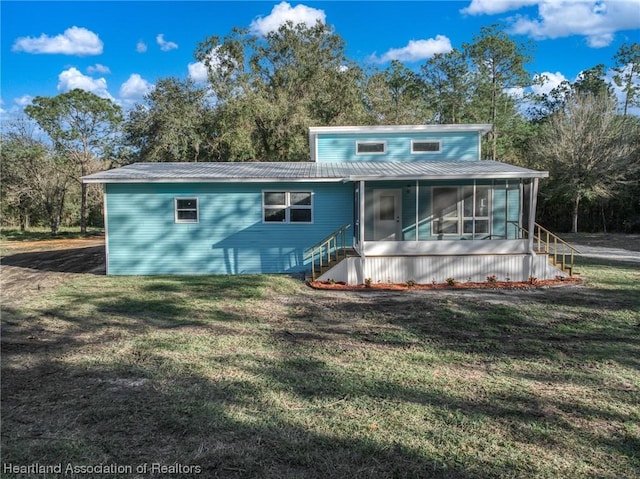 view of front of property with a front lawn and a sunroom