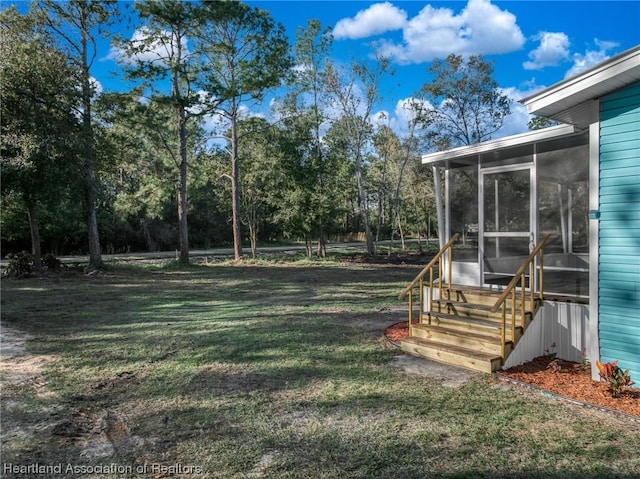 view of yard with a sunroom