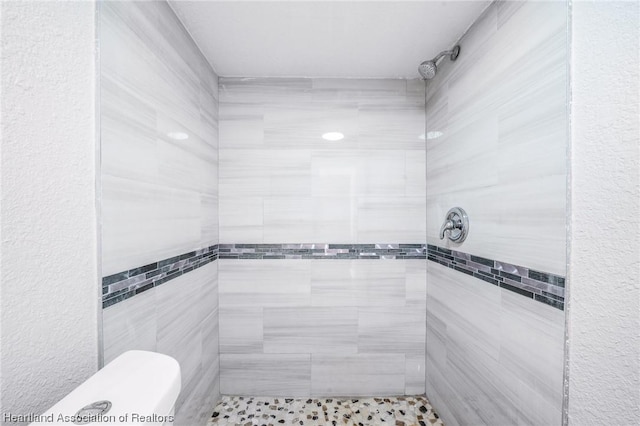 bathroom with tiled shower