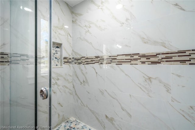 bathroom with tiled shower