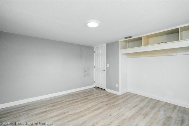 empty room with light hardwood / wood-style floors