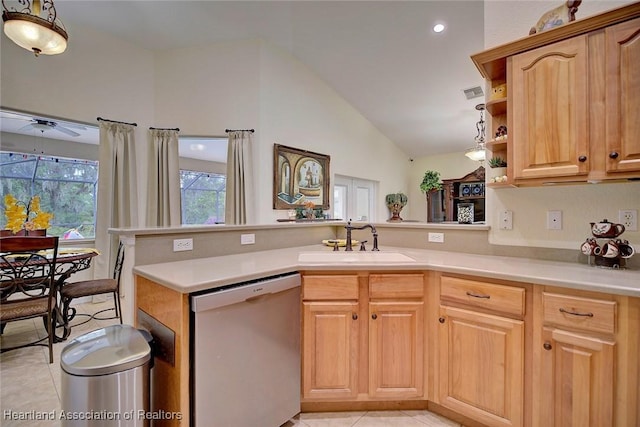 kitchen with dishwasher, kitchen peninsula, sink, and light tile patterned floors