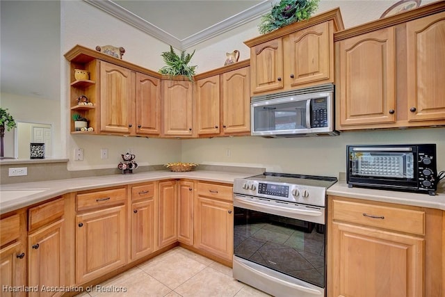 kitchen featuring light tile patterned flooring, stainless steel appliances, and ornamental molding