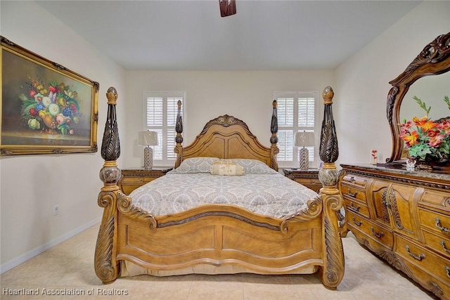 bedroom with ceiling fan and light tile patterned floors