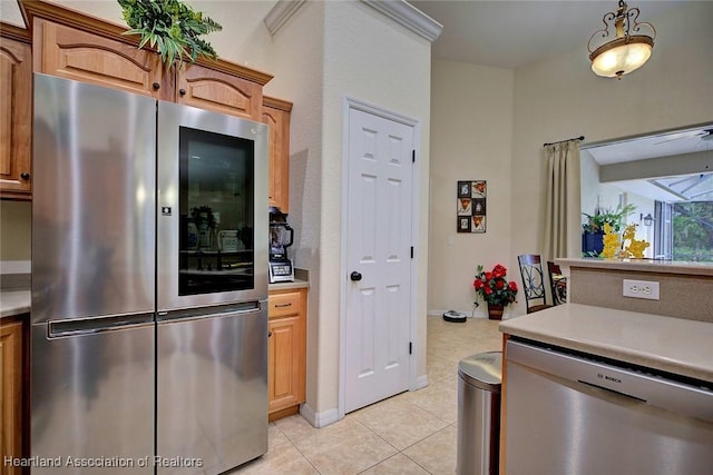 kitchen with pendant lighting, light tile patterned floors, and appliances with stainless steel finishes