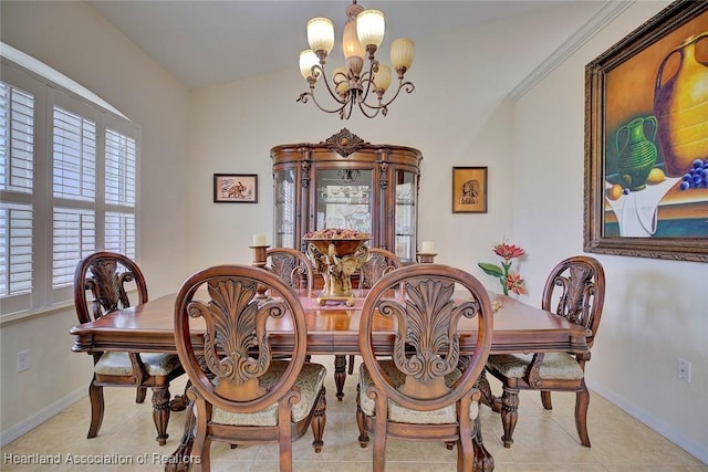 tiled dining area featuring a notable chandelier