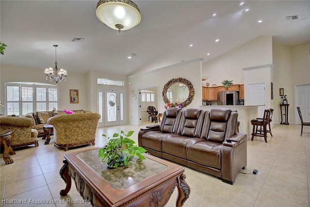 tiled living room with high vaulted ceiling and an inviting chandelier