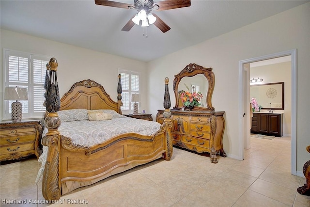 tiled bedroom featuring ensuite bath and ceiling fan