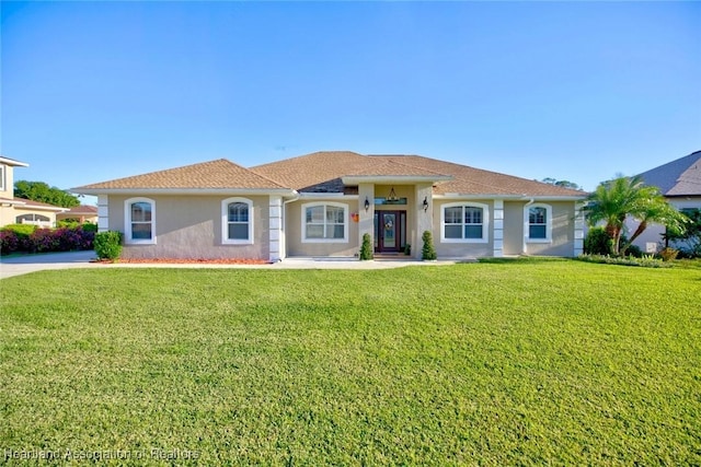 mediterranean / spanish house with a front yard