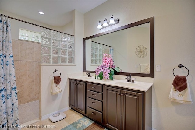 bathroom with a shower with shower curtain, vanity, and tile patterned flooring