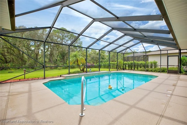 view of swimming pool with a lawn, a lanai, and a patio