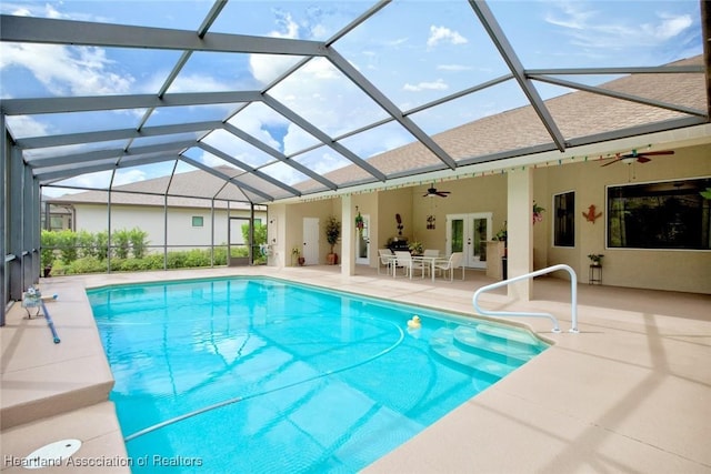 view of pool featuring french doors, a patio, glass enclosure, and ceiling fan