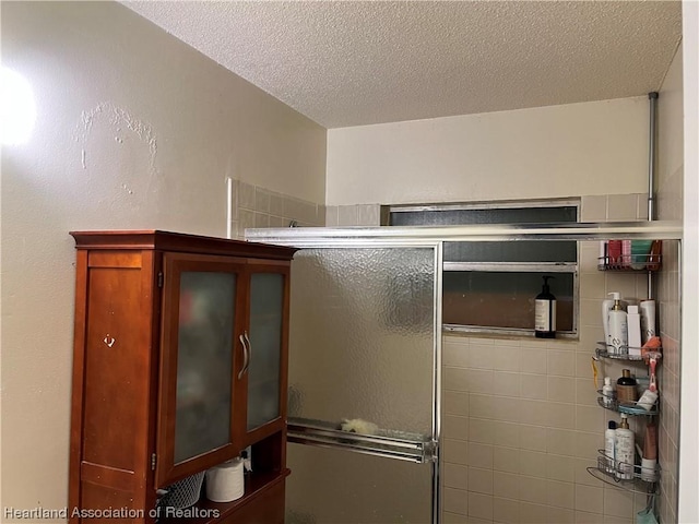 interior space featuring a textured ceiling and walk in shower