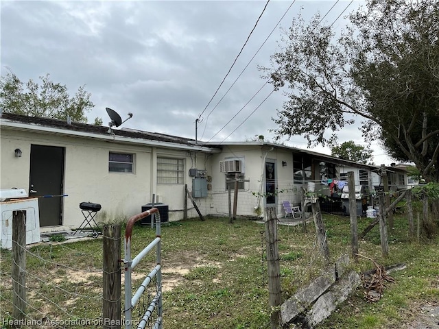 rear view of house with central AC unit