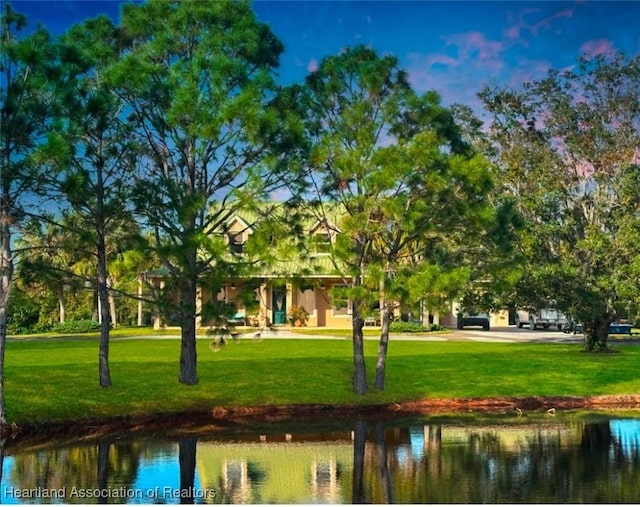 surrounding community featuring a water view and a yard