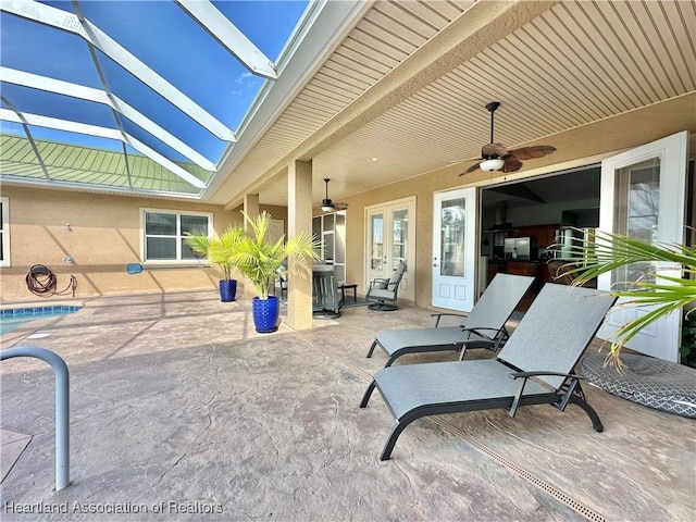 view of patio featuring a lanai and ceiling fan