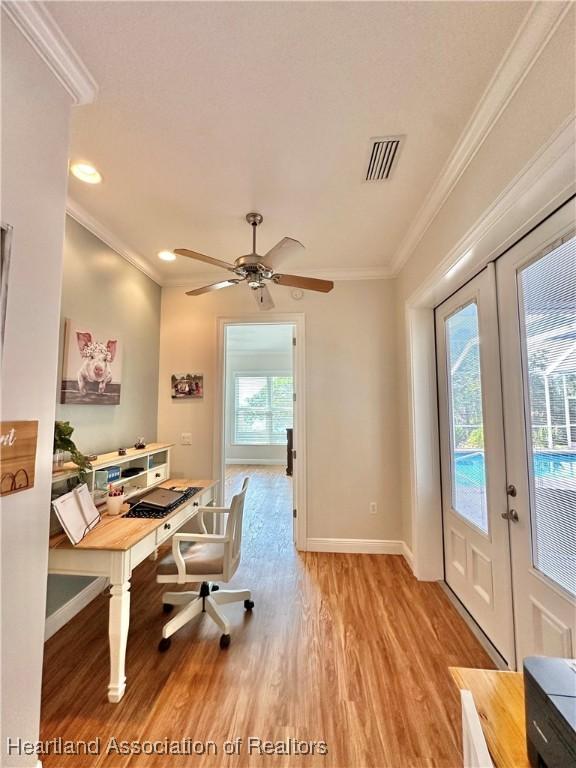 office featuring ceiling fan, crown molding, light hardwood / wood-style flooring, and french doors