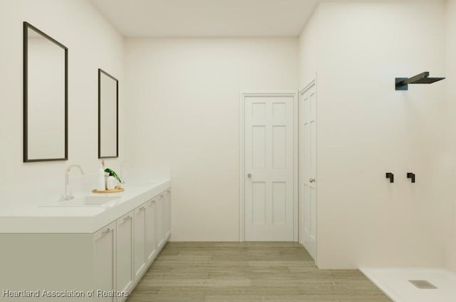 bathroom featuring vanity, hardwood / wood-style floors, and a shower