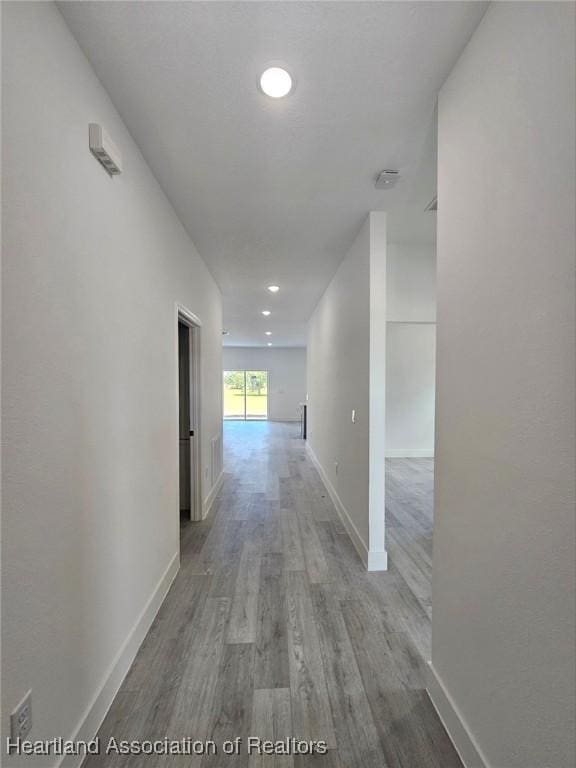 425 Floral Dr, Sebring, FL 33876 - corridor featuring light wood-type flooring, baseboards, and recessed lighting