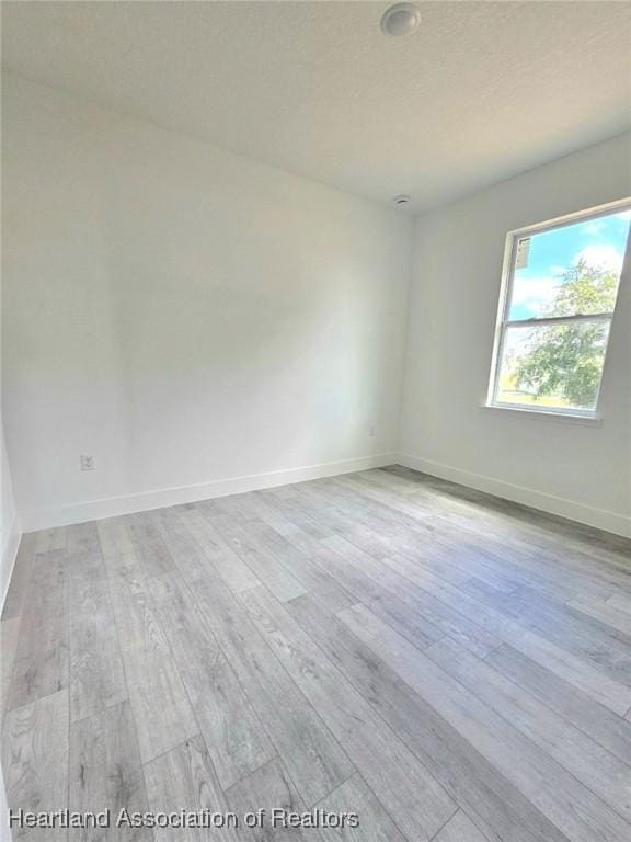 425 Floral Dr, Sebring, FL 33876 - unfurnished room featuring wood finished floors and baseboards