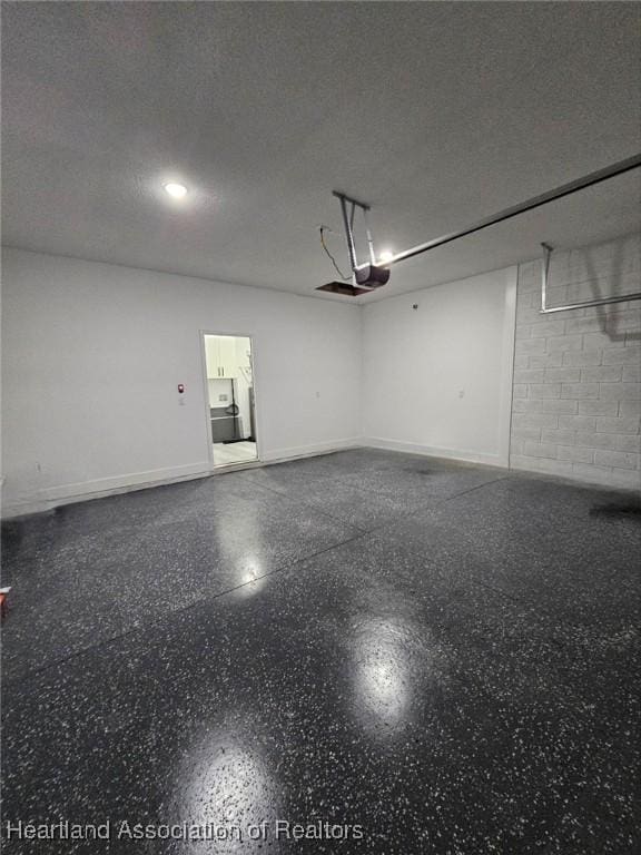 425 Floral Dr, Sebring, FL 33876 - garage with baseboards and concrete block wall