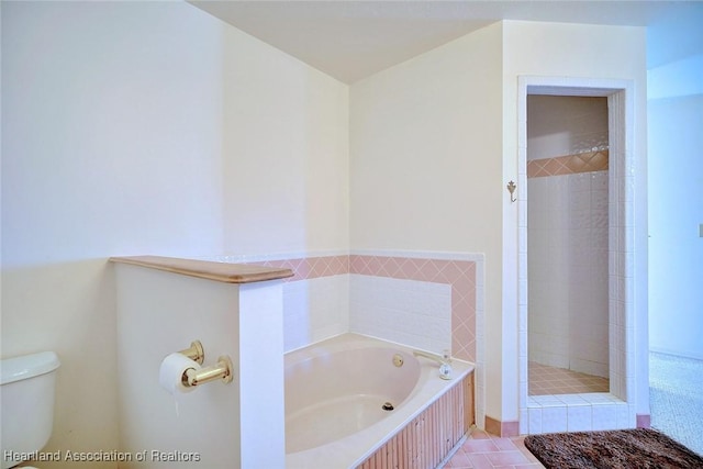 bathroom with tile patterned floors, separate shower and tub, and toilet