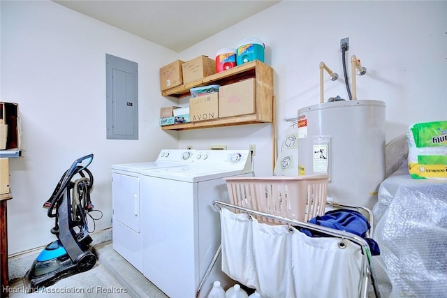 washroom featuring cabinets, electric panel, water heater, and washing machine and clothes dryer