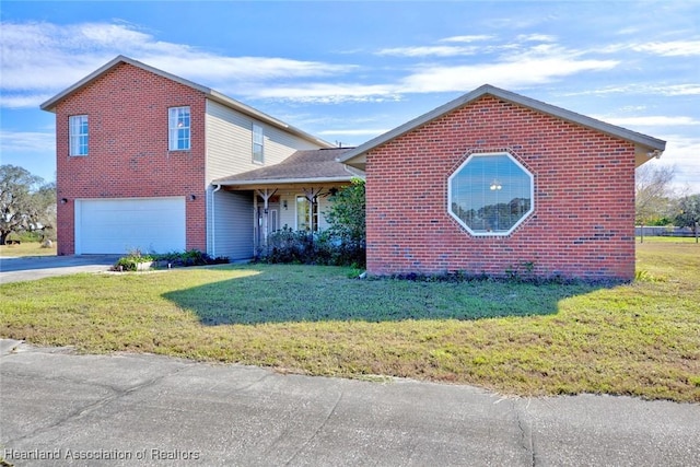 view of front of property featuring a front yard and a garage