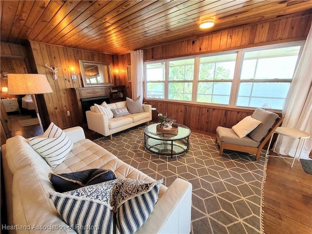 living room featuring wood walls, plenty of natural light, wood ceiling, and dark hardwood / wood-style floors