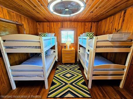 bedroom featuring dark hardwood / wood-style flooring and wood ceiling