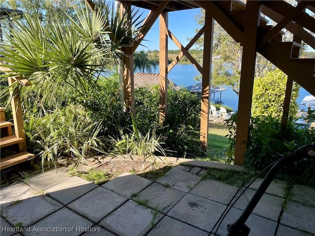 view of patio with a water view