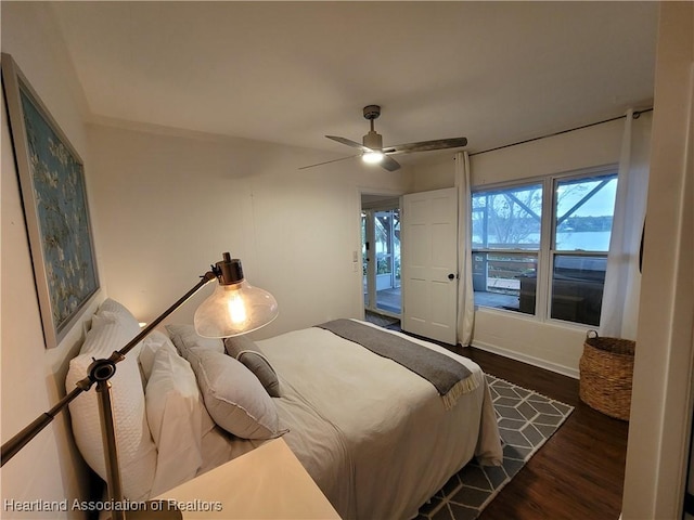 bedroom with dark hardwood / wood-style flooring and ceiling fan