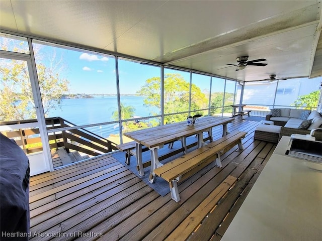 view of dock with an outdoor living space, a water view, and sink