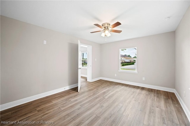 spare room featuring ceiling fan and light hardwood / wood-style floors