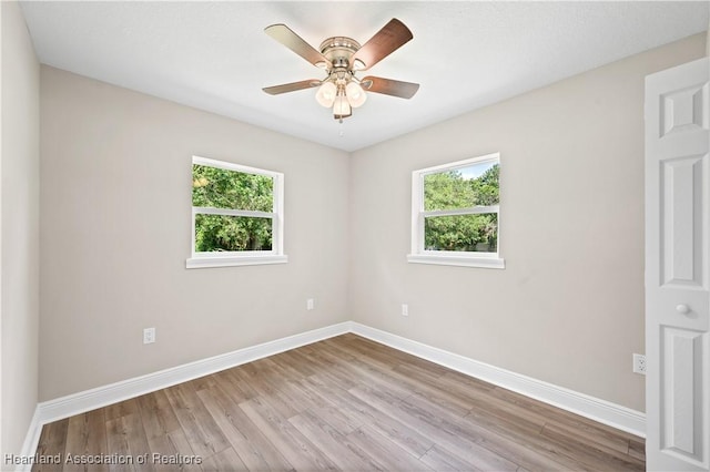 empty room featuring light hardwood / wood-style flooring, plenty of natural light, and ceiling fan