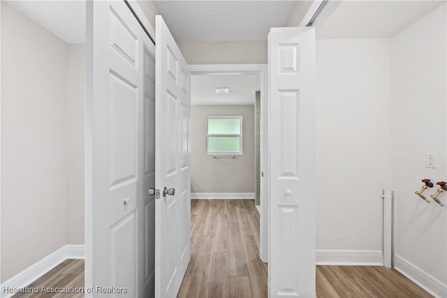 corridor with light hardwood / wood-style floors